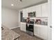 Modern kitchen featuring white cabinets and stainless steel appliances at 115 Spring Wheat Way, Conway, SC 29527