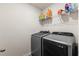 Modern laundry room featuring a front-loading washer and dryer with shelving above at 115 Spring Wheat Way, Conway, SC 29527