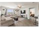Inviting living room featuring hardwood floors, a comfortable sectional sofa, and a modern entertainment center at 115 Spring Wheat Way, Conway, SC 29527