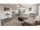 Open-concept living room showcasing a sectional sofa and adjacent kitchen and dining area at 115 Spring Wheat Way, Conway, SC 29527