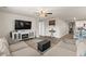 Open-concept living room with comfortable seating, a modern entertainment center, and seamless access to the kitchen at 115 Spring Wheat Way, Conway, SC 29527
