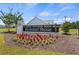 Landscaped entrance sign for Harvest Ridge with colorful flowers and well-manicured greenery at 115 Spring Wheat Way, Conway, SC 29527