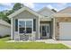 Close up view of front entrance with white rocking chairs and a decorative lighthouse at 1178 Pyxie Moss Dr., Little River, SC 29566