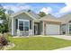 Well-maintained home with a neat lawn, charming facade, and a welcoming front entrance at 1178 Pyxie Moss Dr., Little River, SC 29566