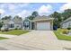 Attractive single-Gathering home with stone accents, a two-car garage, and a well-maintained lawn at 1178 Pyxie Moss Dr., Little River, SC 29566