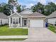Charming single-story home featuring a stone accented garage, rocking chairs, and a well-manicured lawn at 1178 Pyxie Moss Dr., Little River, SC 29566