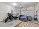 Spacious garage with motorcycle, couch, and plenty of room for storage and activities at 1178 Pyxie Moss Dr., Little River, SC 29566