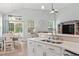 Bright, open-concept kitchen and dining area with stainless appliances, quartz counters, and backyard access at 1178 Pyxie Moss Dr., Little River, SC 29566