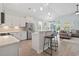 Open-concept kitchen flowing into the living area, featuring a breakfast bar and modern appliances at 1178 Pyxie Moss Dr., Little River, SC 29566