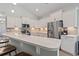 Bright kitchen features stainless appliances, quartz counters, bar seating, and ample storage at 1178 Pyxie Moss Dr., Little River, SC 29566