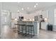 Bright kitchen features stainless appliances, quartz counters, bar seating, and ample storage at 1178 Pyxie Moss Dr., Little River, SC 29566
