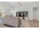 Comfortable living room with a large sofa, entertainment center, ceiling fan, and plenty of natural light at 1178 Pyxie Moss Dr., Little River, SC 29566