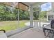 Relaxing screened porch offers views of the landscaped backyard and an outdoor living space at 1178 Pyxie Moss Dr., Little River, SC 29566
