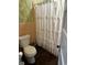 Bathroom with vintage floral wallpaper and a white shower curtain at 124 Orange St., Georgetown, SC 29440