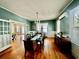 Dining room boasts hardwood floors, traditional wainscotting, french doors and decorative chandelier at 124 Orange St., Georgetown, SC 29440