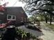 Charming brick home featuring a lovely patio area with a water feature and lush landscaping at 124 Orange St., Georgetown, SC 29440