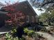 Exterior view featuring brick facade, side yard, outdoor patio and lush landscaping at 124 Orange St., Georgetown, SC 29440