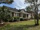 Traditional brick home with inviting front porch framed by white columns and colorful landscaping at 124 Orange St., Georgetown, SC 29440