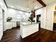 Bright kitchen featuring a stylish island with marble countertops, stainless steel appliances, and hardwood flooring at 124 Orange St., Georgetown, SC 29440