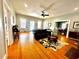 Spacious living room boasts gleaming hardwood floors, a ceiling fan, and a seamless flow into the dining area at 124 Orange St., Georgetown, SC 29440