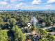 Aerial view of a residence nestled within a green landscape, near the ocean and city skyline at 1300 Ragin St., Myrtle Beach, SC 29577