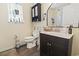 Well-lit bathroom featuring a vanity, mirror, and storage cabinet at 1300 Ragin St., Myrtle Beach, SC 29577