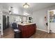 Open-concept living space featuring a kitchen island with granite countertops and wood cabinets at 1300 Ragin St., Myrtle Beach, SC 29577