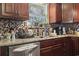 Beautiful kitchen featuring granite countertops, stainless steel dishwasher, and decorative tile backsplash at 1300 Ragin St., Myrtle Beach, SC 29577