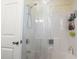 Bathroom shower featuring white tub and walls, a shower head, and caddy with toiletries at 1300 Ragin St., Myrtle Beach, SC 29577