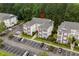 Aerial view showcasing a condo building with parking, green spaces, and balconies at 1302 River Oak Dr. # 4B, Myrtle Beach, SC 29579