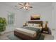 Cozy bedroom with a wood-framed bed, soft lighting, and a large window offering natural light at 1302 River Oak Dr. # 4B, Myrtle Beach, SC 29579