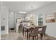 Inviting dining area with a marble table set for four, adjacent to a bright kitchen with bar seating at 1302 River Oak Dr. # 4B, Myrtle Beach, SC 29579