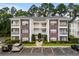 Well-maintained condo building featuring brick accents, private balconies, and manicured landscaping for curb appeal at 1302 River Oak Dr. # 4B, Myrtle Beach, SC 29579
