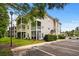 Attractive condo exterior with screened porches, well-maintained landscaping, and convenient parking in a desirable area at 1302 River Oak Dr. # 4B, Myrtle Beach, SC 29579