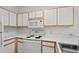 Kitchen featuring white appliances and light wood trim cabinets at 1302 River Oak Dr. # 4B, Myrtle Beach, SC 29579