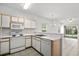 Kitchen with white appliances and breakfast bar offering an open view to the living area at 1302 River Oak Dr. # 4B, Myrtle Beach, SC 29579