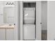 Bathroom view showcasing a convenient stacked washer and dryer unit for in-unit laundry at 1302 River Oak Dr. # 4B, Myrtle Beach, SC 29579