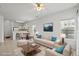 Bright, staged living room with neutral furniture, large windows, and an open floor plan to the dining area at 1302 River Oak Dr. # 4B, Myrtle Beach, SC 29579