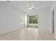 Spacious living area featuring access to an outdoor patio, natural light, and neutral tile flooring at 1302 River Oak Dr. # 4B, Myrtle Beach, SC 29579