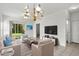 Elegant living room with modern decor, featuring plush seating, a large TV, and access to a green outdoor space at 1302 River Oak Dr. # 4B, Myrtle Beach, SC 29579