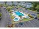 Aerial view of a large community pool area with lounge chairs, lush landscaping and parking at 1302 River Oak Dr. # 4B, Myrtle Beach, SC 29579