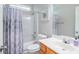Well-lit bathroom featuring a vanity, toilet, and shower-tub combination with a stylish patterned curtain at 161 Patriot Ln., Pawleys Island, SC 29585