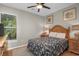 Comfortable bedroom showcasing a bed with a dark patterned bedspread, wooden furniture, and ample natural light at 161 Patriot Ln., Pawleys Island, SC 29585
