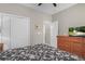 Bedroom boasts a closet and dresser with a television and a comfortable bed with dark patterned linens at 161 Patriot Ln., Pawleys Island, SC 29585