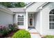 Inviting front entrance with elegant windows, stylish lighting, and a beautiful garden at 161 Patriot Ln., Pawleys Island, SC 29585