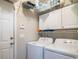 Laundry room with washer, dryer, shelving, and storage cabinets for your laundry needs at 161 Patriot Ln., Pawleys Island, SC 29585