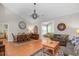 Spacious living room and dining area featuring hardwood floors and vaulted ceilings at 161 Patriot Ln., Pawleys Island, SC 29585