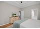 Spacious main bedroom with tray ceiling, dresser, and view to ensuite bathroom at 161 Patriot Ln., Pawleys Island, SC 29585