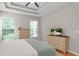 The main bedroom boasts tray ceiling, bright windows, and neutral decor at 161 Patriot Ln., Pawleys Island, SC 29585