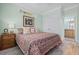 Comfortable bedroom featuring decorative bedding, neutral walls, and light wood-look flooring at 17 Trigger Fish Ln., Murrells Inlet, SC 29576